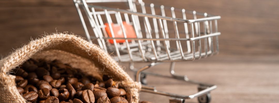 Box with shopping cart on coffee beans, Import Export Shopping online or eCommerce delivery service store product shipping, trade, supplier concept.